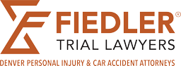 Logo for Fiedler Trial Lawyers with the tagline "Denver Personal Injury & Car Accident Attorneys" in orange text on a light background.