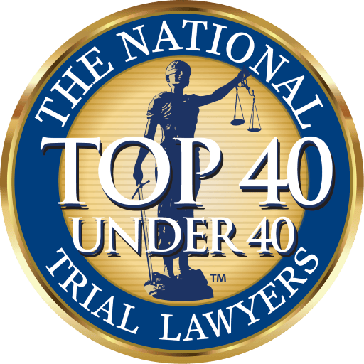 Circular badge reading "The National Trial Lawyers: Top 40 Under 40" with Lady Justice holding scales in the center on a gold and blue background.